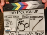 Close-up shot of a clapperboard from the set of new pilot show entitled They F*ck You Up
